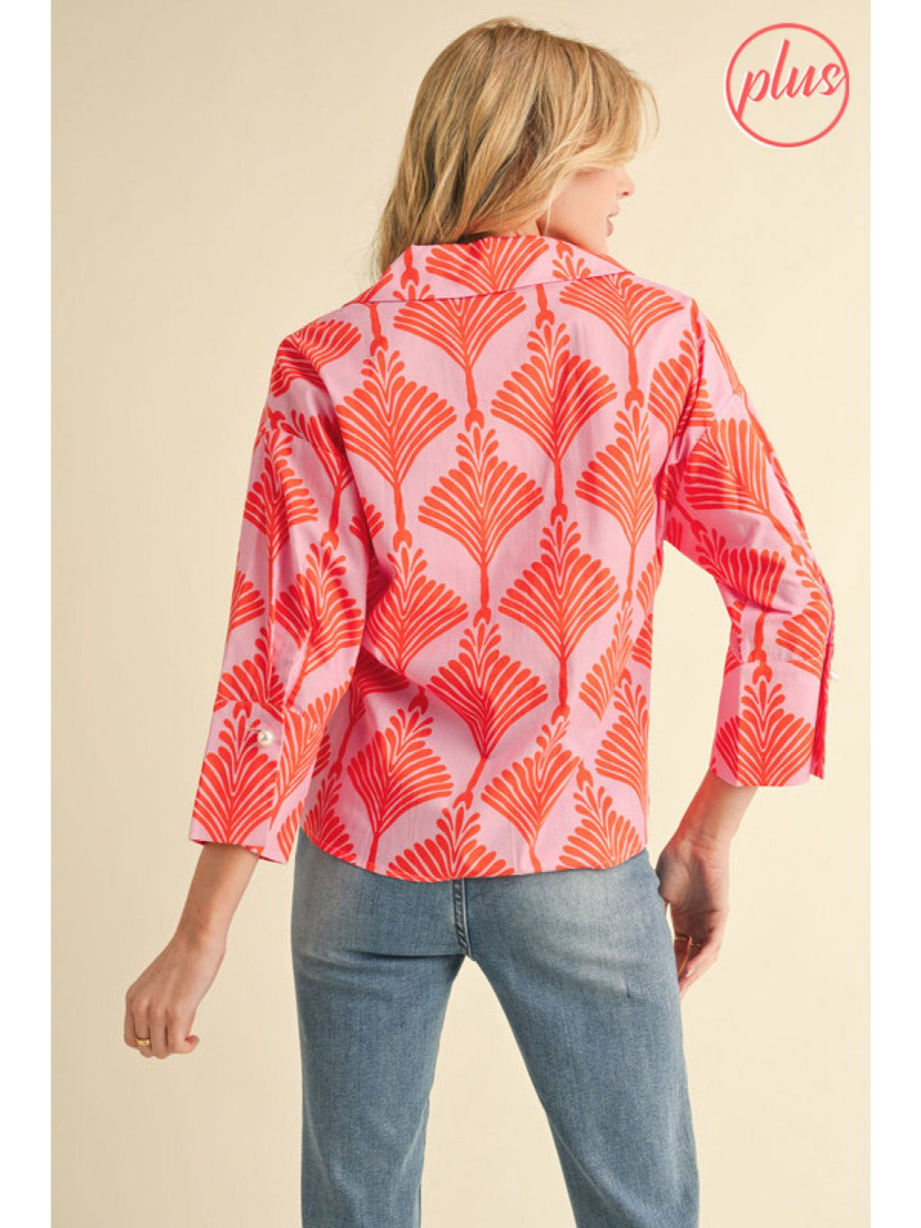 Plus size orange print blouse with three-quarter sleeves and pearl cuff, perfect for coastal boutique clothing styles.