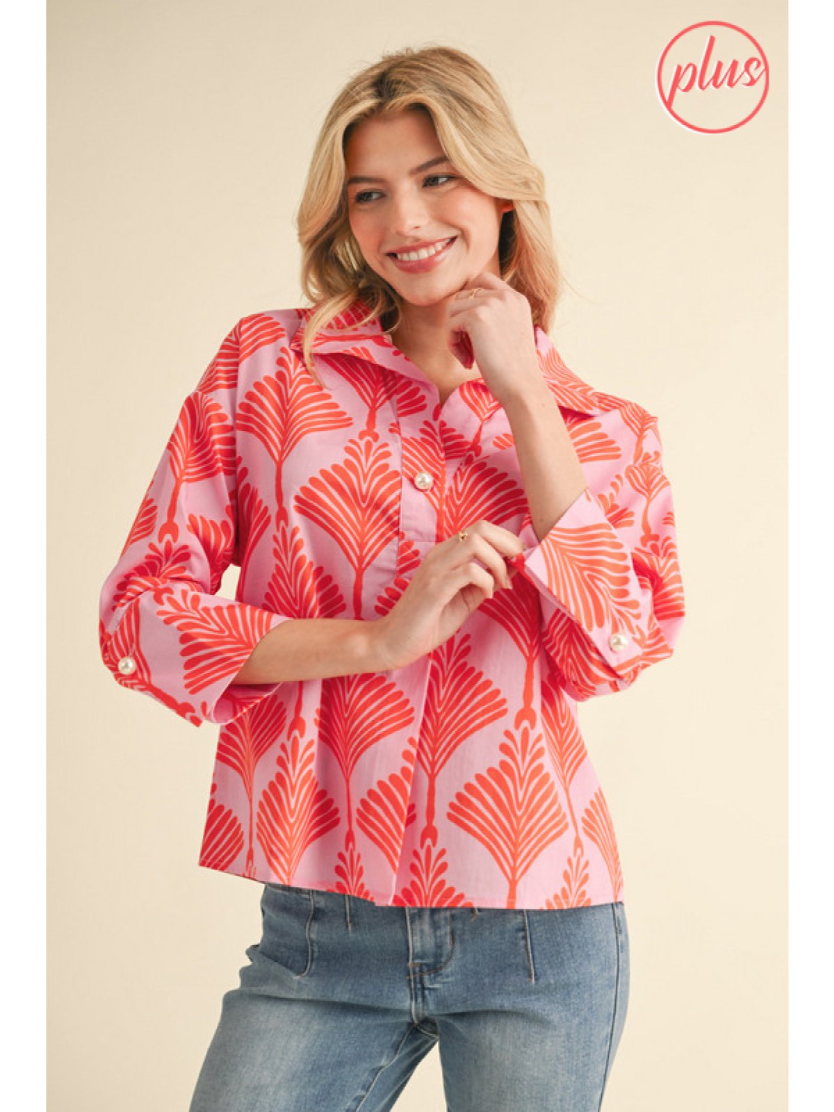 Plus size orange print top featuring a collared neckline and pearl buttons, perfect for coastal boutique clothing.