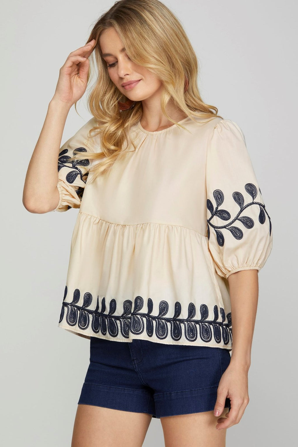 Embroidered light taupe top, perfect for coastal boutique clothing and stylish summer looks. Ideal for tropical vacations.