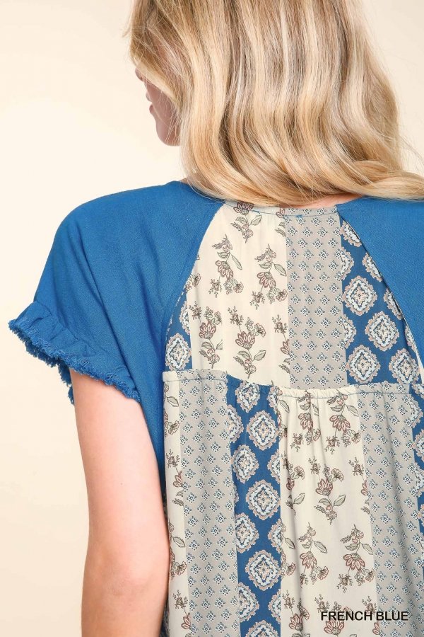 Stylish French blue top showcasing decorative contrast back, perfect for coastal boutiques and Port Aransas women's fashion.