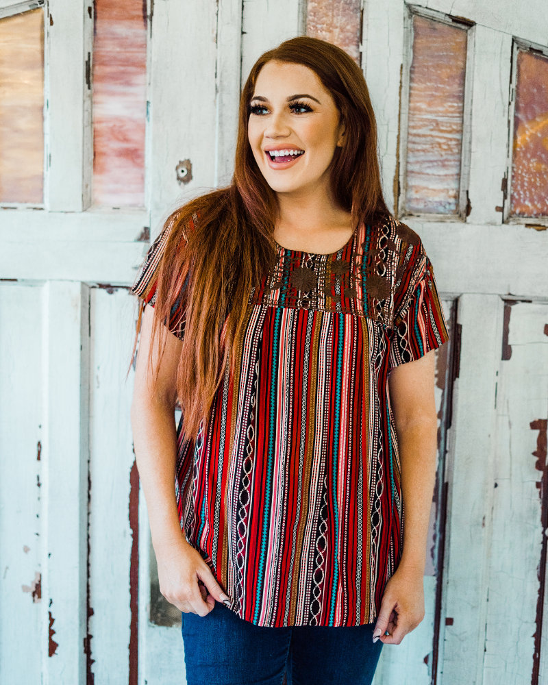 Woman wearing PLUS RAELYNN TOP from Raggdoll Boutique, showcasing trendy coastal style and summer outfits Texas.