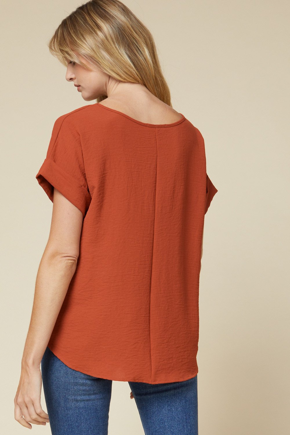 SIMPLE SCOOP NECK TOP-RUST back view showcasing rolled sleeves, asymmetrical hem, lightweight design for summer outfits Texas.
