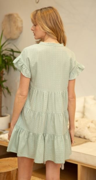 SAGE DRESS WITH TASSELS at Raggdoll Boutique, a stylish baby doll dress with tassels in sage green.