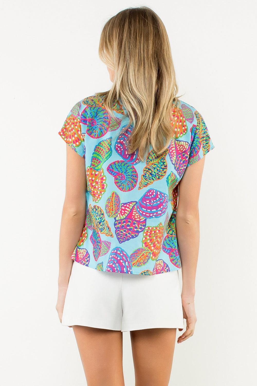 Lara Top featuring vibrant leaf patterns, perfect for coastal boutique clothing and stylish beach dresses.