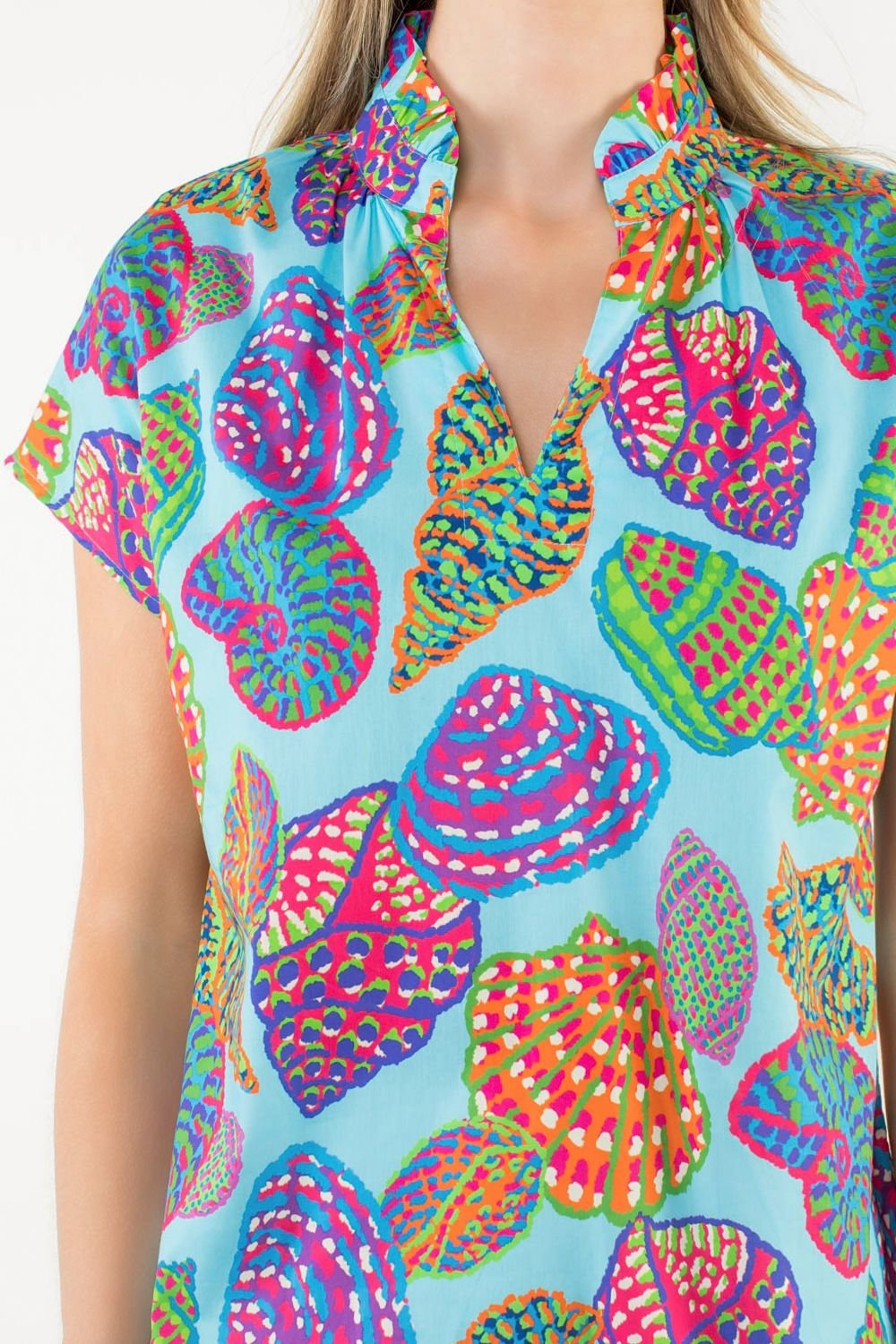 Colorful Lara Top featuring vibrant sea shell prints, perfect for a coastal boutique clothing collection.