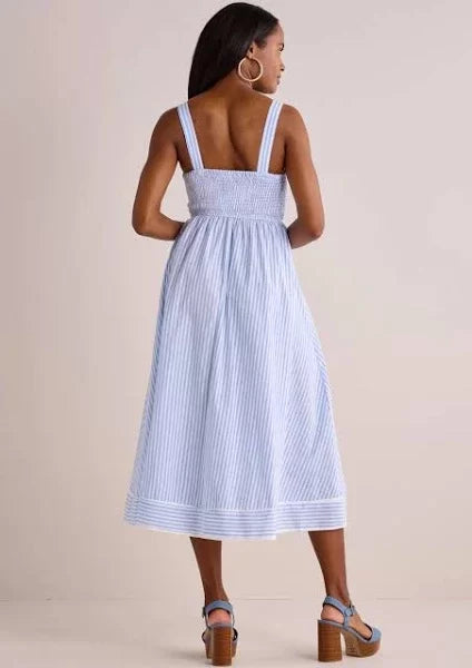 Model showing the back view of the Beyond the Sea Dress, a blue and white striped midi dress from Raggdoll Boutique.