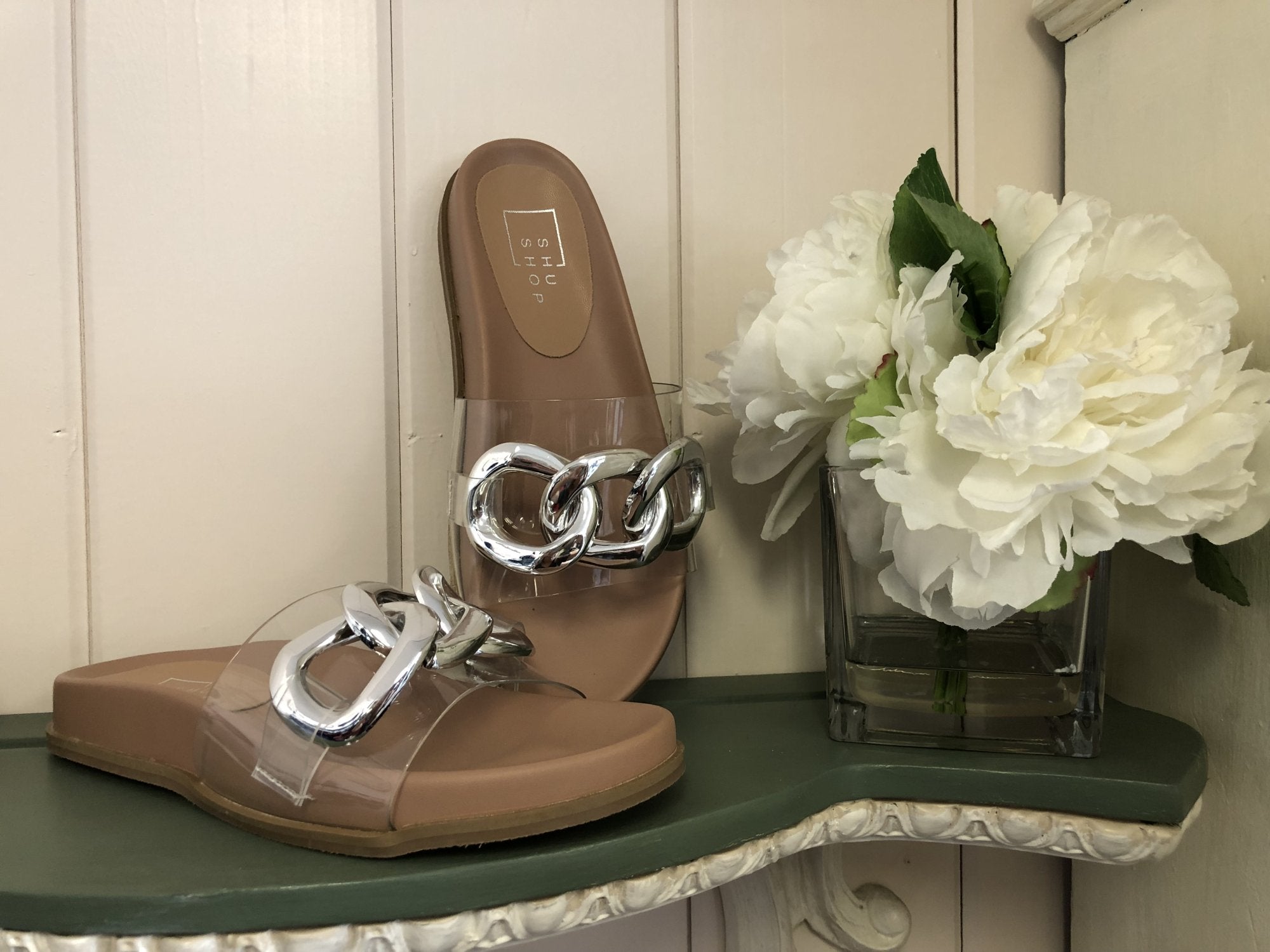 CLEAR/SILVER DETAIL SANDAL displayed with peonies at Raggdoll Boutique, a coastal fashion boutique.
