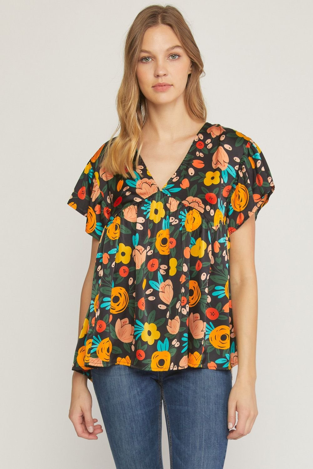 BLACK FLOWER PRINT TOP featuring vibrant colors and floral design, ideal for coastal fashion from Raggdoll Boutique.