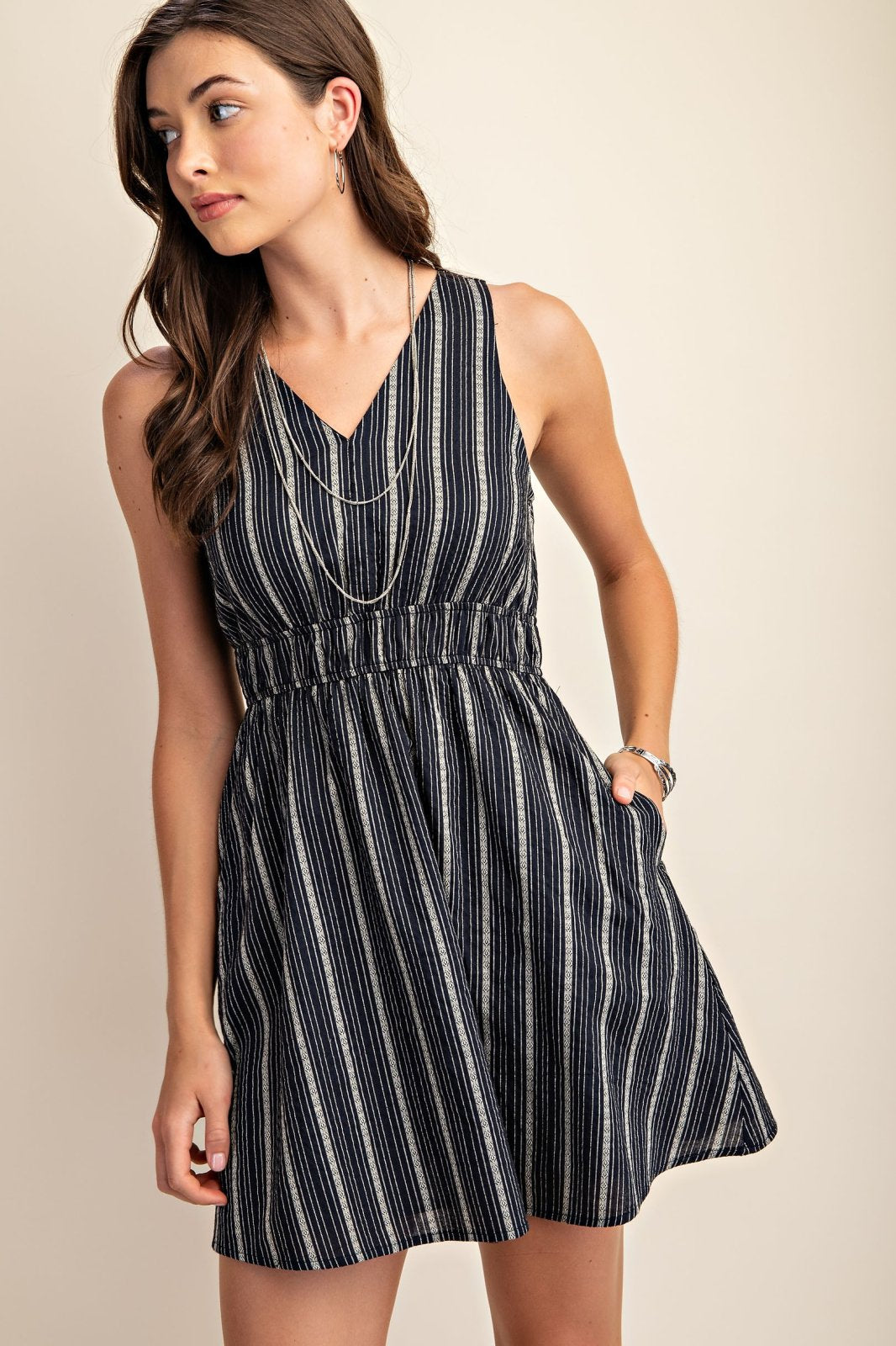 Jordan Dress: Striped dress from a coastal boutique, perfect for tropical vacations and styled with sneakers or sandals.