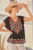 Model wearing PLUS EMBROIDERED SAVANNA JANE TOP with hat, showcasing trendy coastal style from Raggdoll Boutique.