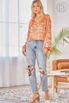 TAUPE, RUST, GOLD FLORAL TOP styled with distressed jeans in a chic coastal fashion setting from Raggdoll Boutique.