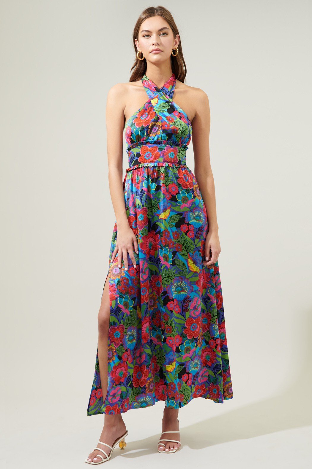 Model wearing the IN THE TROPICS DRESS with vibrant floral print, halter style, and side slit, perfect for vacation and summer outfits.