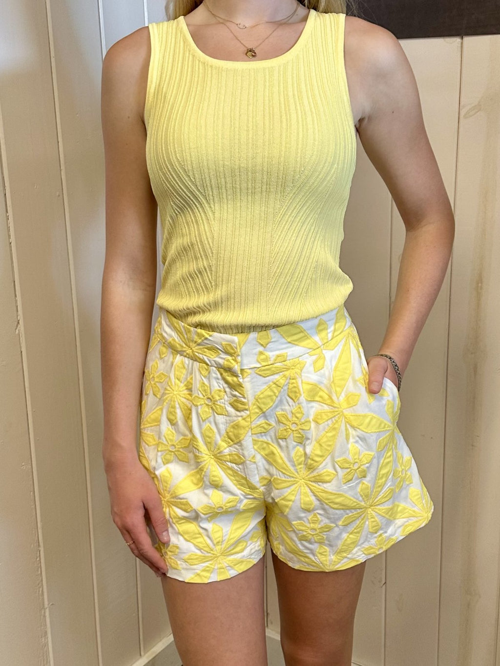 Vibrant yellow cami shorts with floral embroidery, paired with matching tank top from a Port Aransas boutique, ideal for summer.