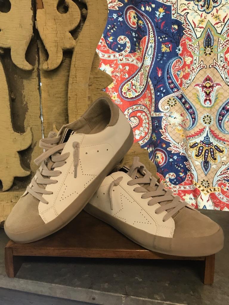 MIA WHITE STAR SNEAKER displayed on a stand, perfect for trendy coastal style at Raggdoll Boutique in Port Aransas.