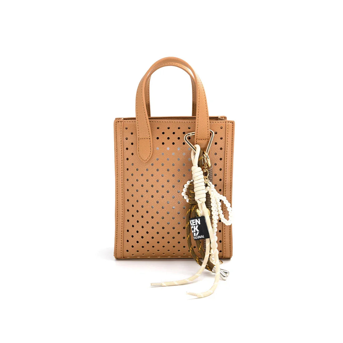 Stylish beige perforated purse with keychain, perfect for coastal boutique clothing and gifts in Port Aransas.