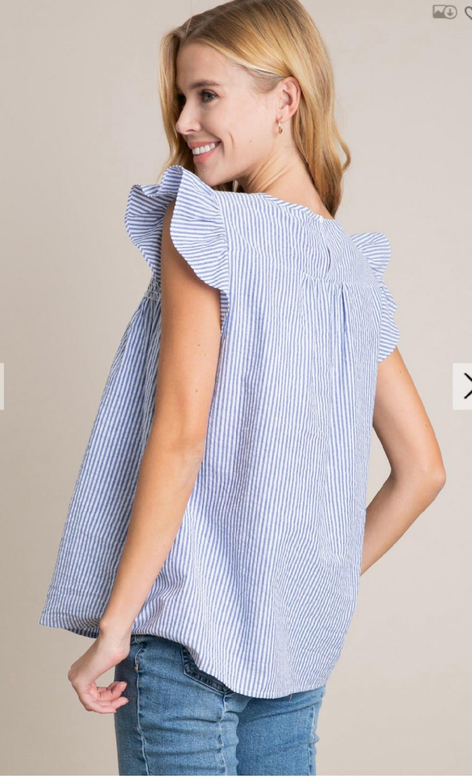 Blue and white seersucker embroidered top featuring ruffled sleeves, perfect for beach dresses and coastal boutique clothing.