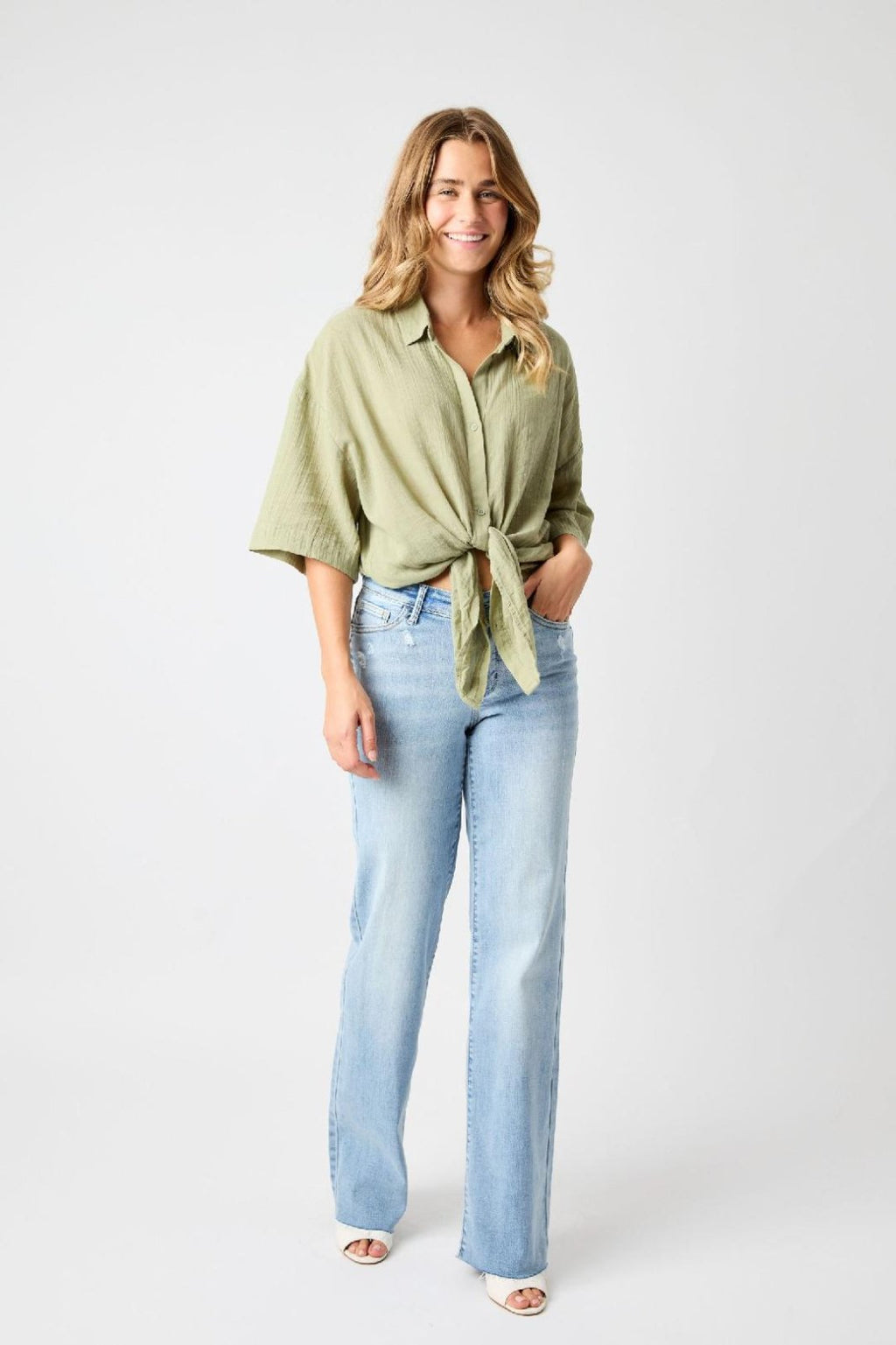 JUDY BLUE HW V FRONT WAISTBAND STRAIGHT FIT (FREY HEM) styled with a trendy green top and light blue jeans.