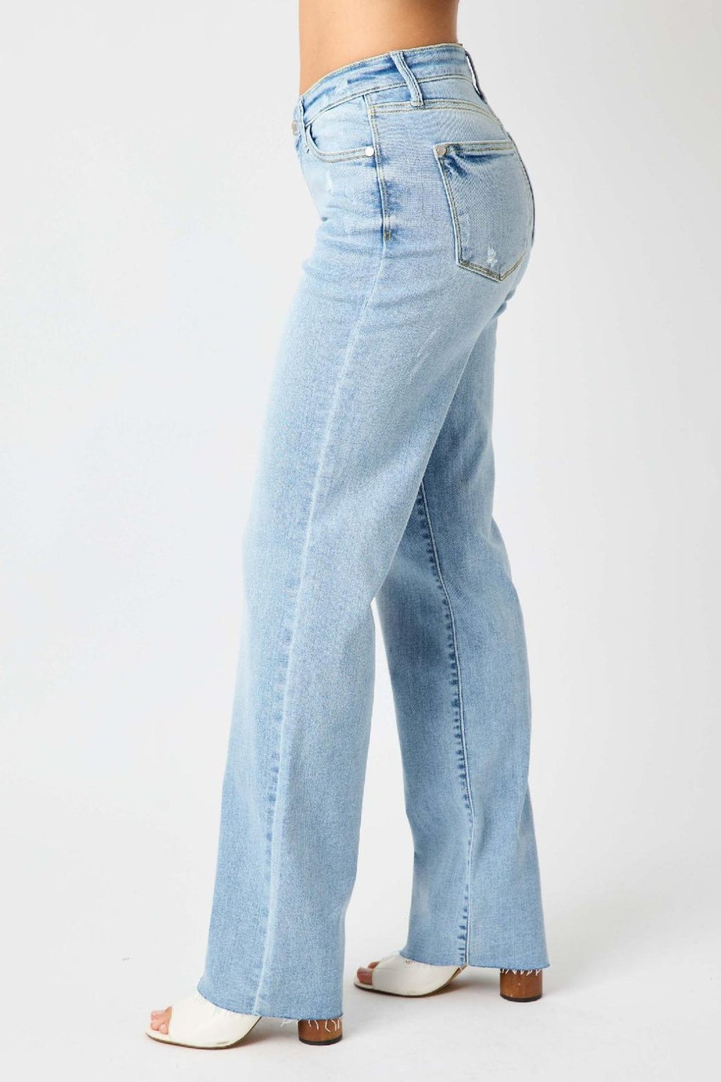 JUDY BLUE HW V FRONT WAISTBAND STRAIGHT FIT (FREY HEM) side view in light blue denim at Raggdoll Boutique.