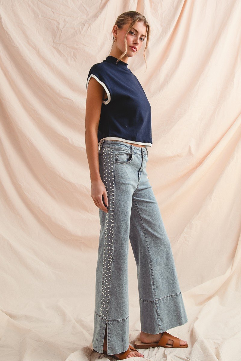Model showcasing Pearl Glow Flare Jeans with pearl embellishments, perfect for coastal boutique clothing and trendy women's fashion.