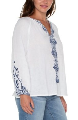 LIVERPOOL OFF WHITE TOP WITH NAVY EMBROIDERED DETAILS worn with jeans, perfect for trendy coastal style from Raggdoll Boutique.