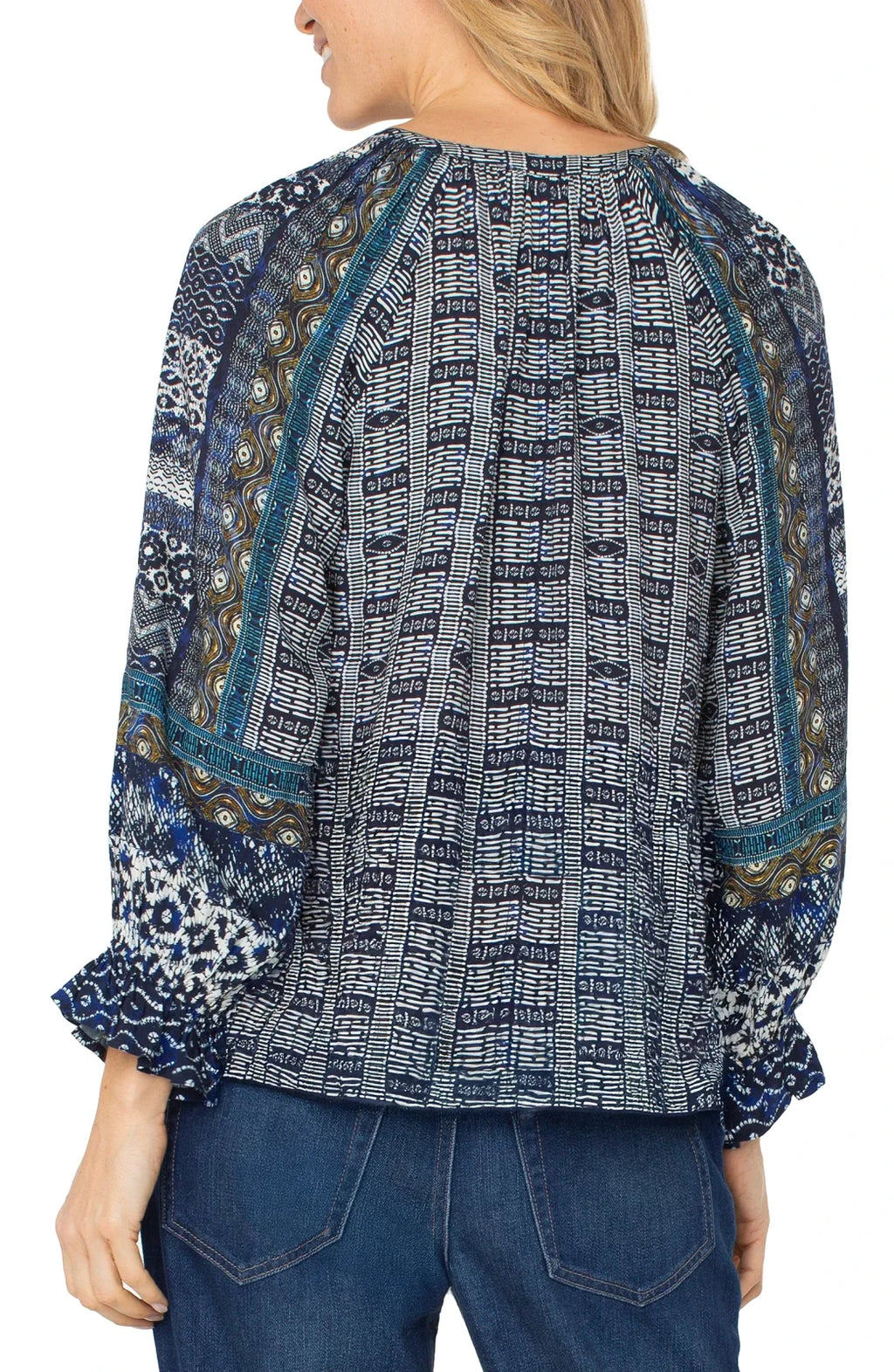 Stylish blue shibori blouse from Liverpool with ruffled cuffs, perfect for coastal boutique clothing and tropical vacation styles.