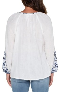LIVERPOOL OFF WHITE TOP WITH NAVY EMBROIDERED DETAILS, back view featuring detailed sleeves.
