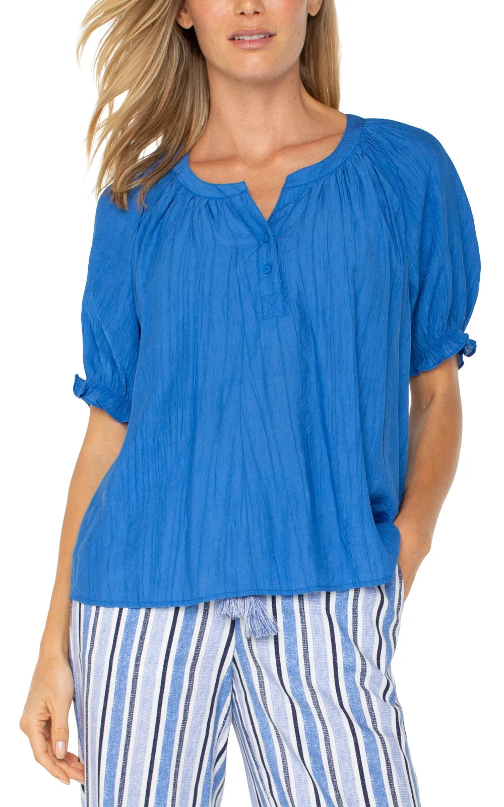 LP cobalt blue blouse with puff sleeves, ideal for coastal boutique clothing, styled with striped pants for summer events.