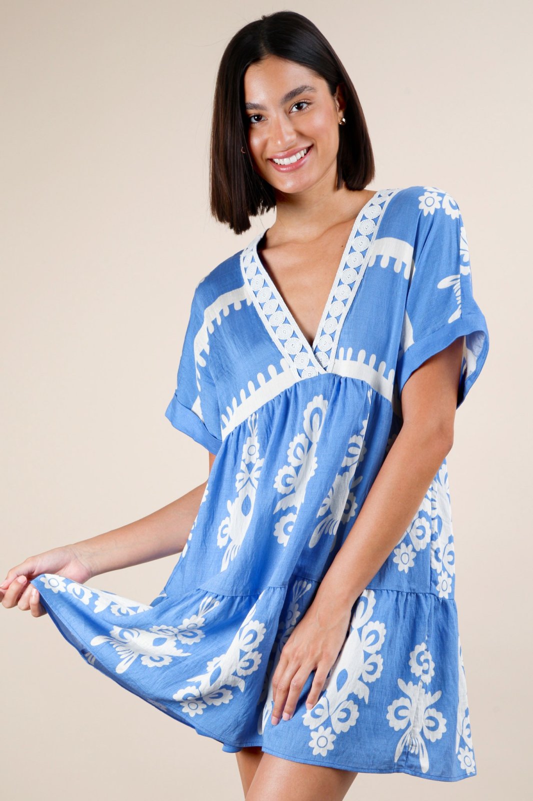 Sky blue mini dress with embroidered V-neck and boho charm, perfect for coastal boutique clothing and tropical vacation outfits.