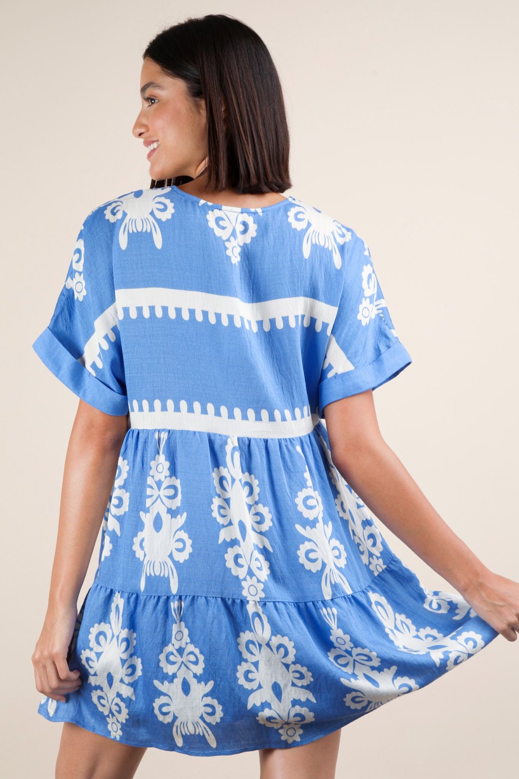 Sky blue mini dress from a coastal boutique, showcasing boho charm with delicate prints and an embroidered V-neckline.