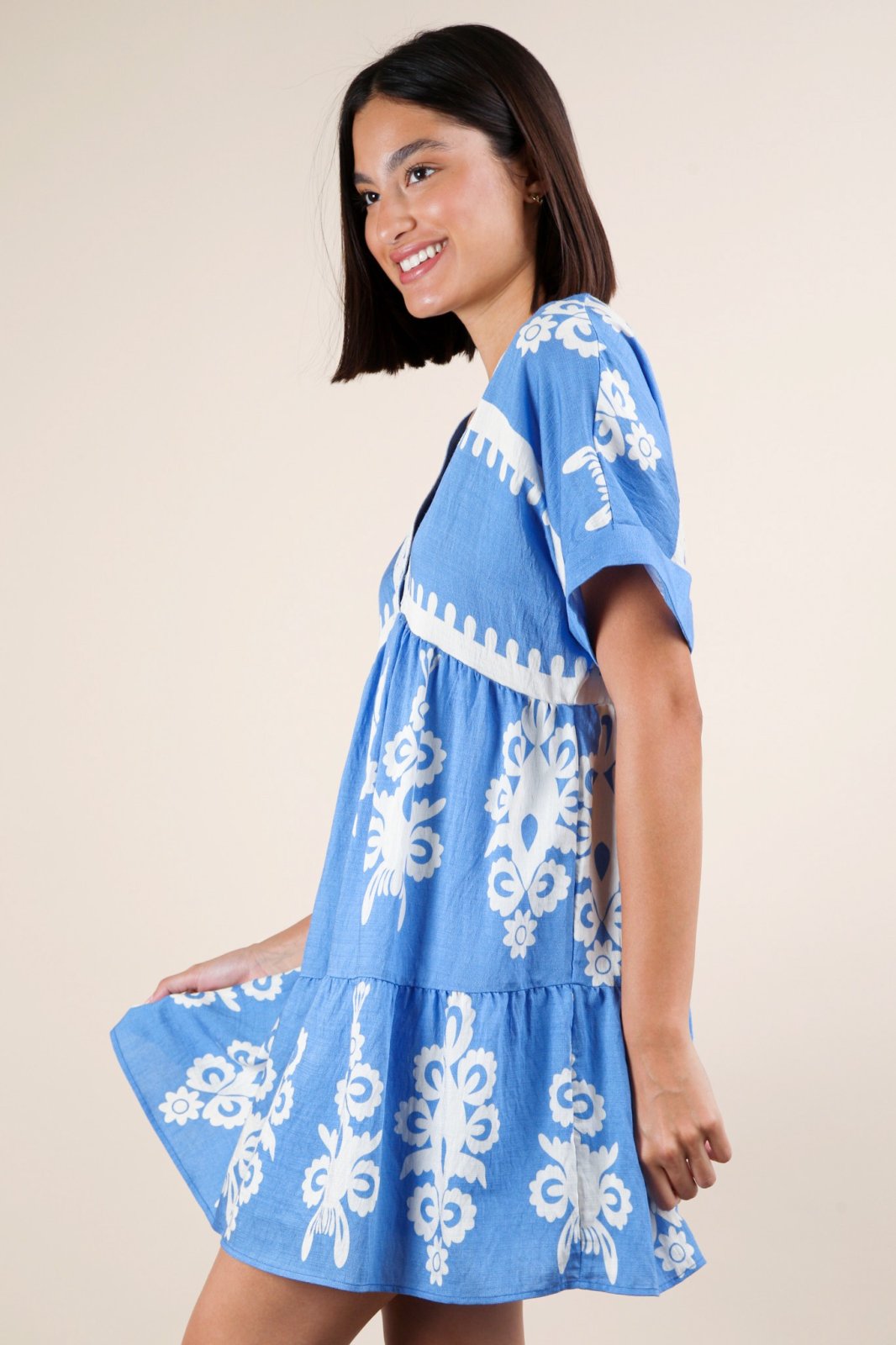 Sky blue mini dress with embroidered V-neck and boho charm, ideal for coastal boutique clothing and tropical vacations.