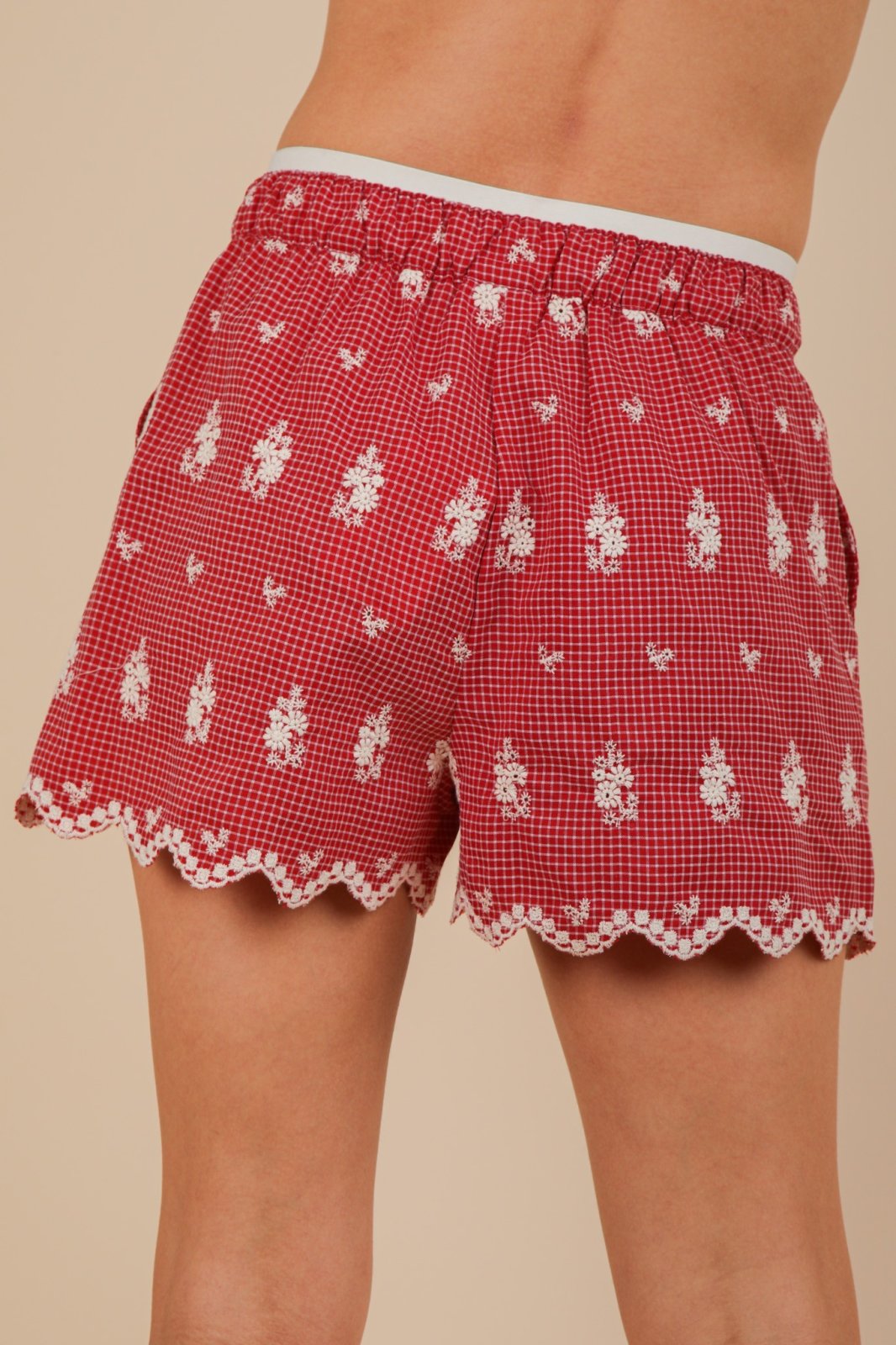 Vibrant red Sami shorts with scalloped hem, perfect for coastal boutique clothing and warm tropical vacations.