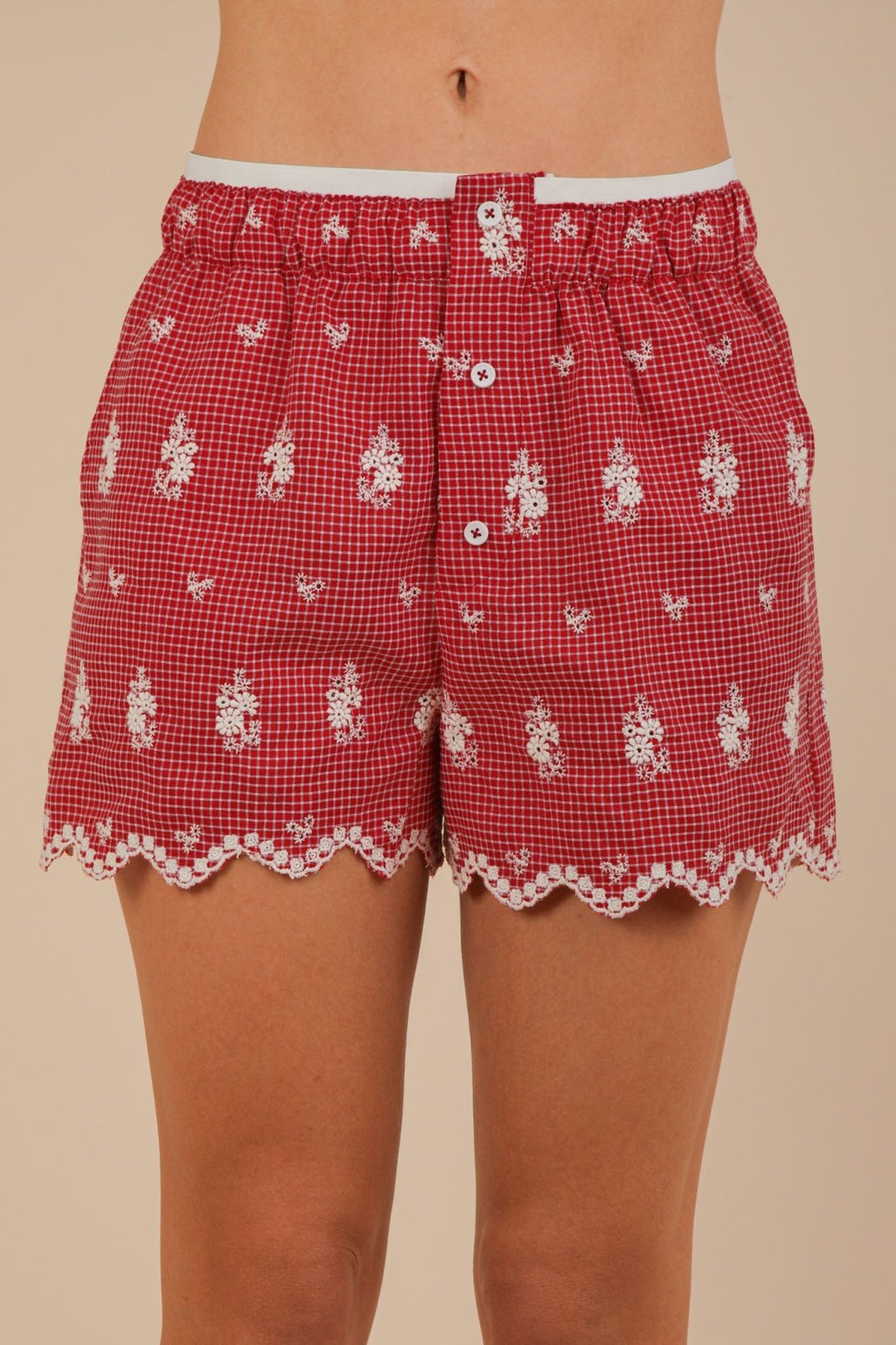 Vibrant red Sami shorts with scalloped hem, ideal for coastal boutique clothing and summer casual wear.