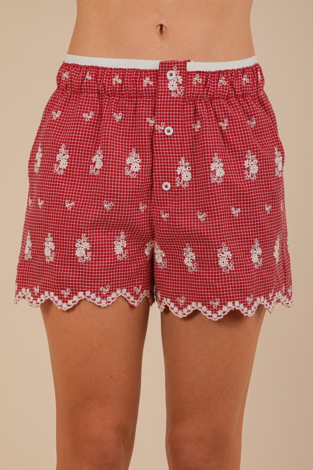 Vibrant red Sami shorts with scalloped hem, ideal for coastal boutique clothing and summer casual wear.
