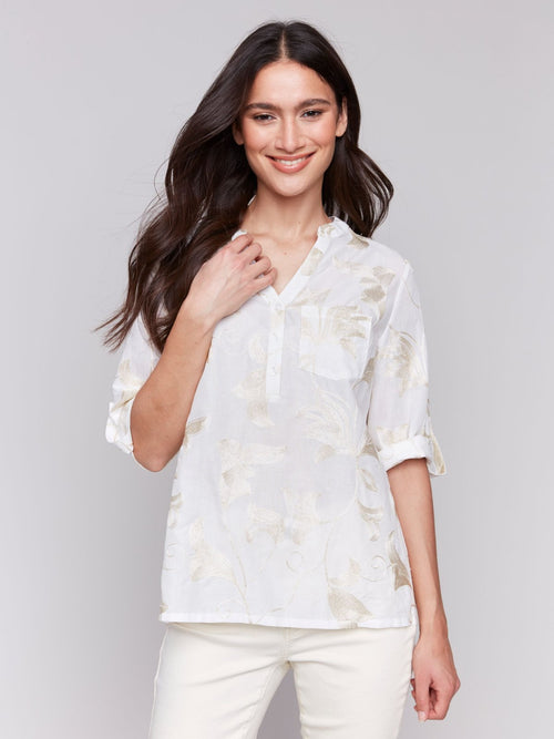 Stylish white and gold embroidered top, perfect for coastal boutique clothing and tropical vacation dresses.