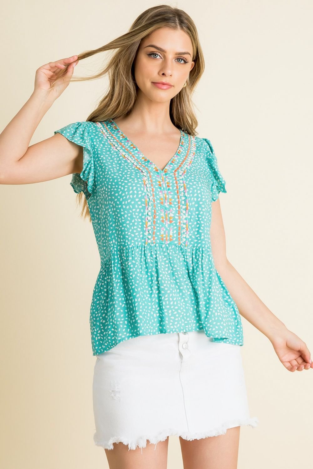 Aqua embroidered flutter top paired with a white skirt, showcasing coastal boutique clothing for a fresh summer look.