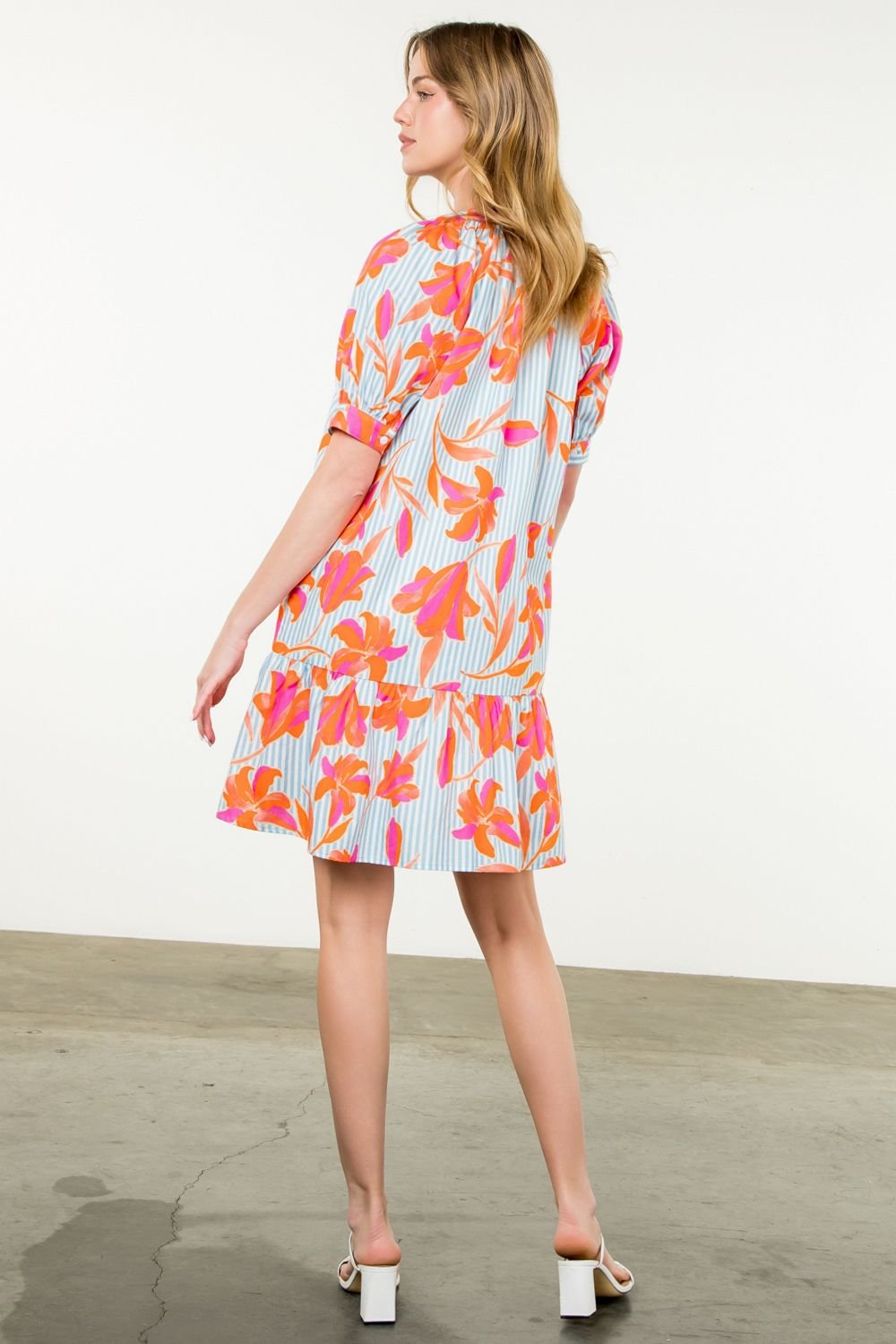 Cameron Dress featuring bold flowers and stripes, perfect for brunch dates at coastal boutiques or tropical vacations.