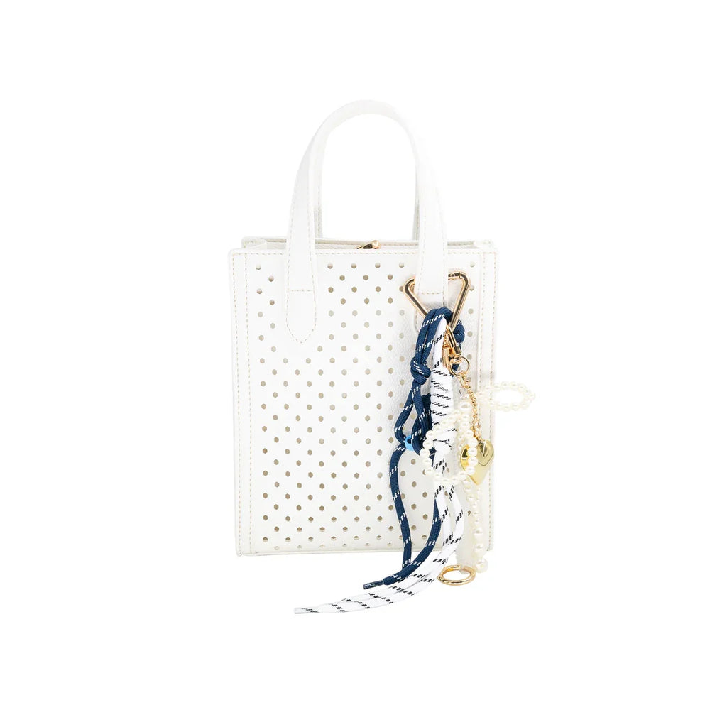 Stylish white dotted Ines Purse with colorful charm, perfect coastal boutique accessory for curated women's fashion.