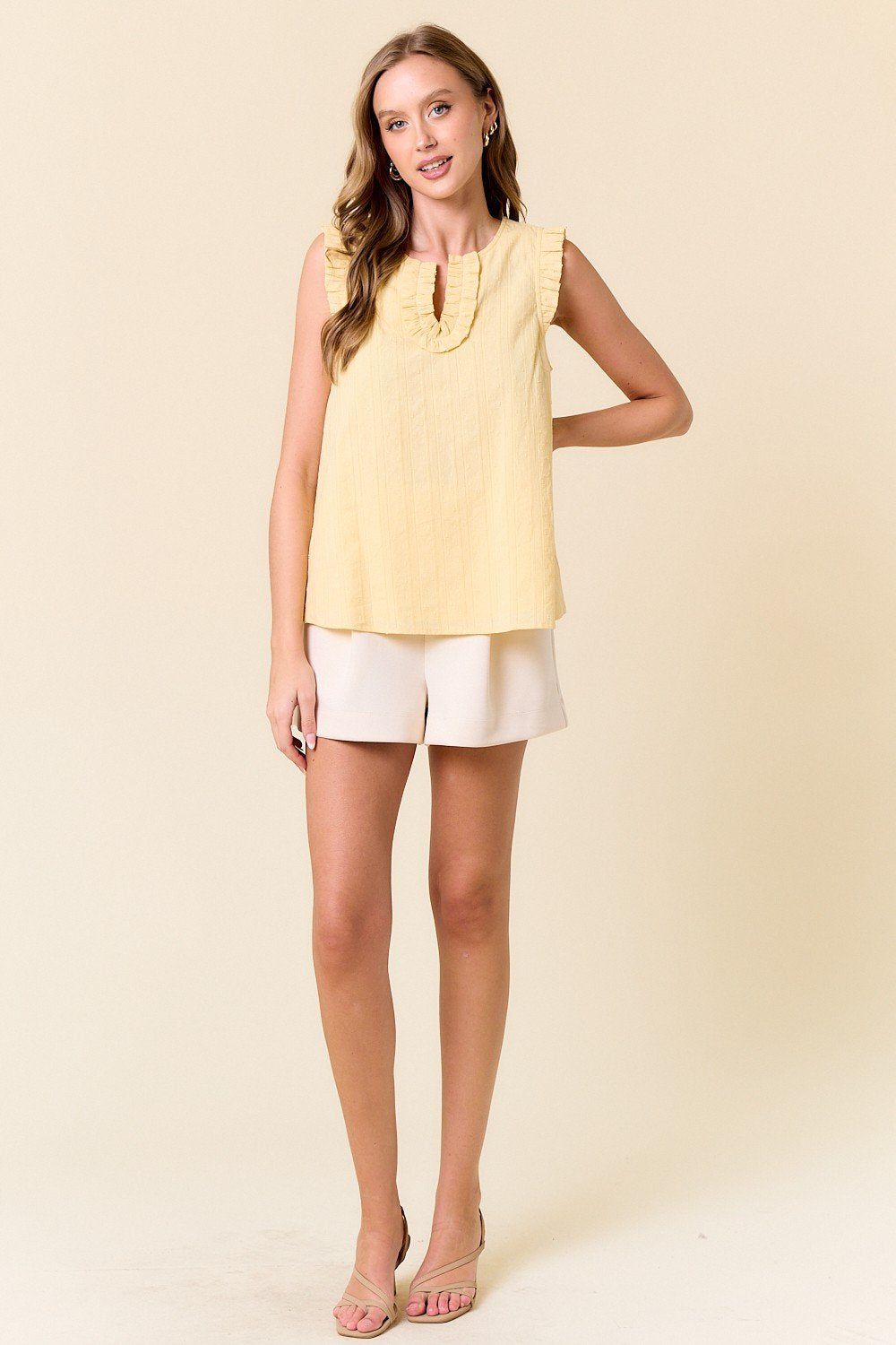 Pastel yellow ruffled tank top from a coastal boutique, perfect for beach dresses and curvy plus size fashion styles.